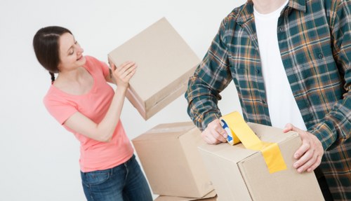 Careful furniture carrying through a narrow apartment stairwell