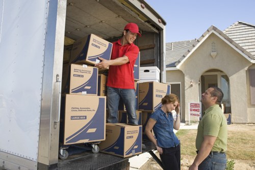 Local furniture pick-up service loading items from a residential property